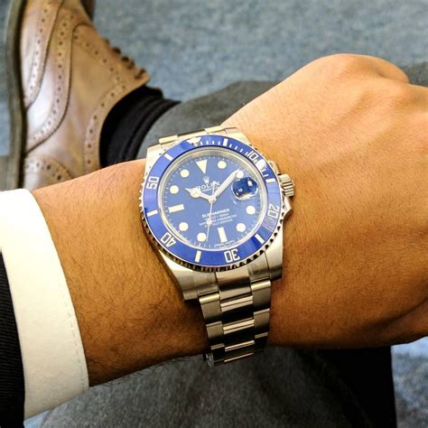 rolex submariner blue on wrist.